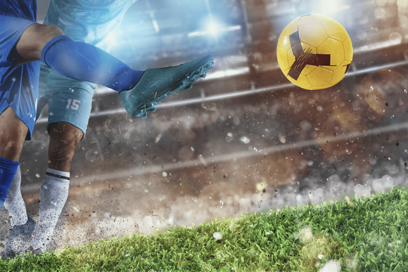 Guide complet de la Coupe du monde 2026 entre nouveau format et paris sportifs 1 Joueur de football en pleine action, tentant de bloquer ou de dévier le ballon lors d'un match de football dynamique.